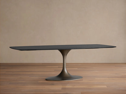 The image shows the edge of a Saint Germain Wood Dining Table in an Ebony finish, highlighting the solid oak and veneer grain.