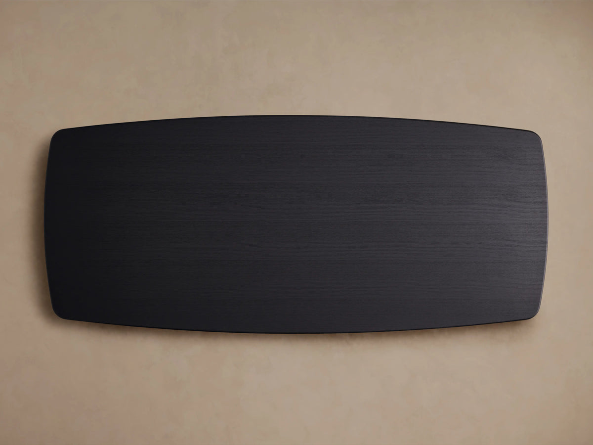Oblong black tabletop of the Saint Germain Wood Dining Table, made from solid oak with an Ebony finish, viewed from above.