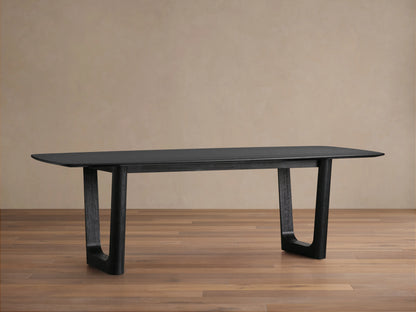 Saint Germain dining table with Ebony-finished solid oak top and unique Rennes base on a hardwood floor, against a neutral wall.