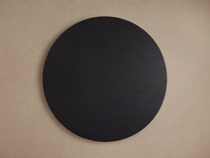 Round wooden tabletop with dark ebony finish, showing wood grain texture against a neutral background.