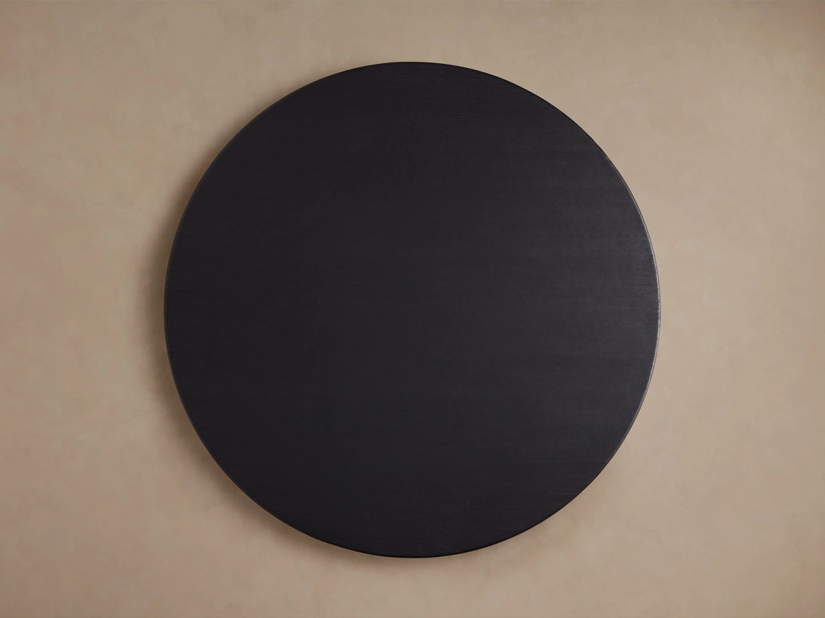 Round wooden tabletop of the Saint Germain Dining Table, showcasing a dark Ebony finish with visible wood grain texture.