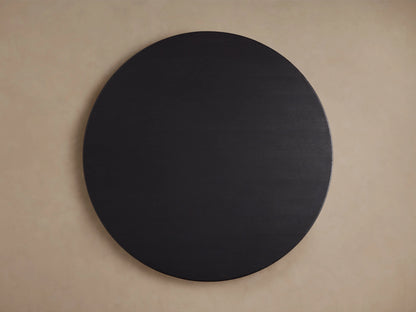 Round wooden tabletop of the Saint Germain Dining Table, showcasing a dark Ebony finish with visible wood grain texture.