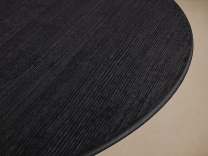 Saint Germain Round Wood Dining Table with a smooth, dark ebony finish, shown from a top-down perspective against a neutral background.
