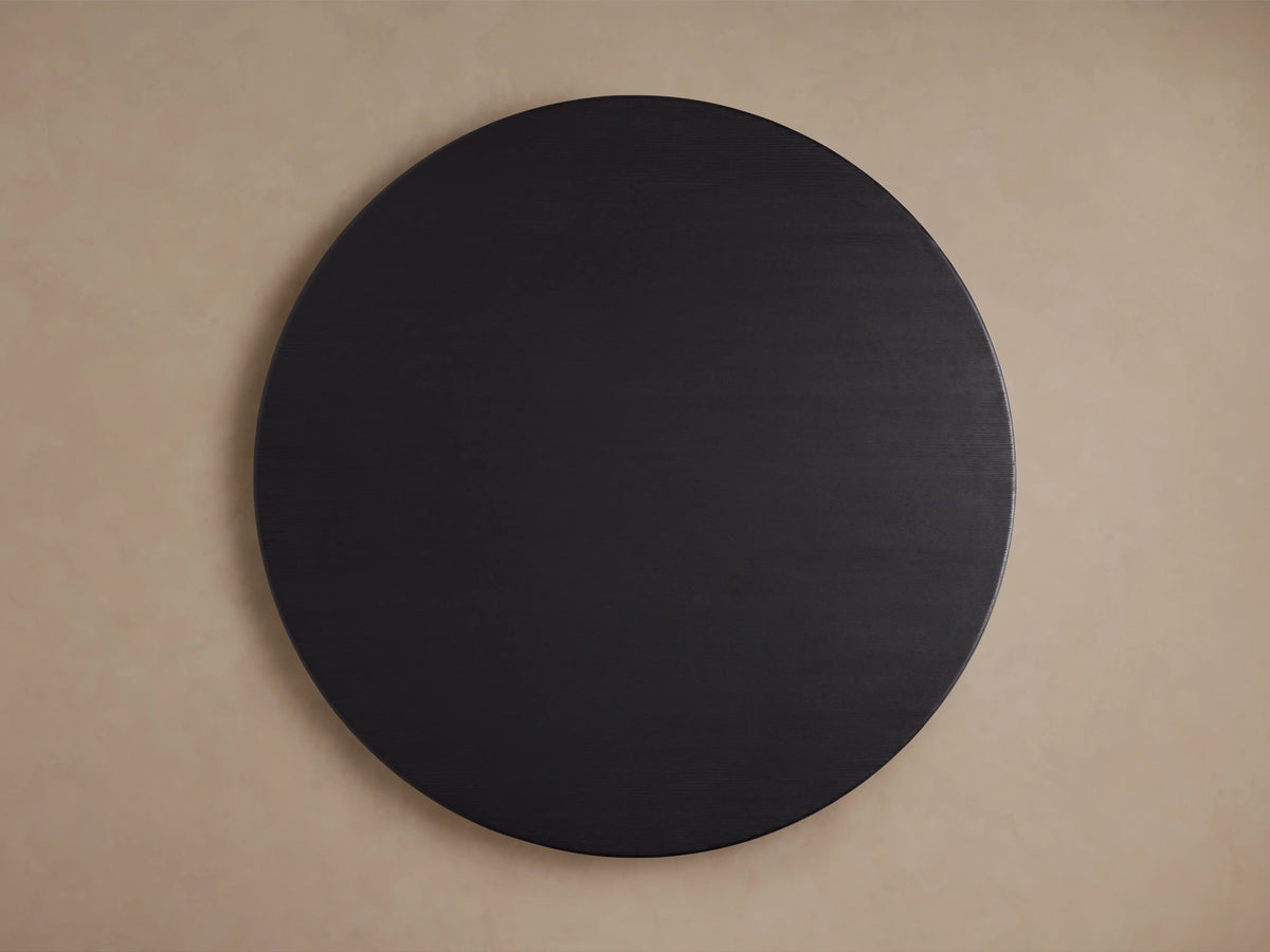 Round tabletop of the Saint Germain Dining Table in Ebony finish, showcasing solid oak wood grain texture.
