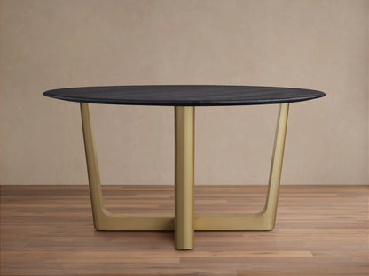 The Saint Germain Round Wood Dining Table features a dark oak tabletop and a wide, V-shaped Rennes base in antique brass on a wood floor.