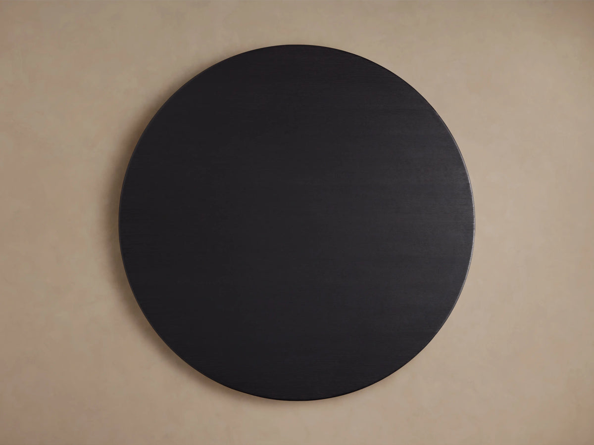 Round wooden tabletop of the Saint Germain Dining Table in Ebony finish, showcasing the dark, textured oak grain.