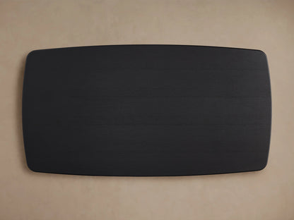 Close-up of the Saint Germain Wood Dining Table's corner, showcasing its solid oak surface in an Ebony finish.