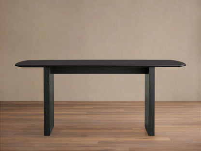 Saint Germain dining table with solid oak top and rectangular base, finished in dark Ebony, on wooden floor.