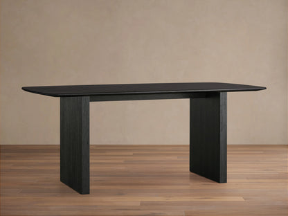 Saint Germain dining table with solid oak top and rectangular base, finished in dark Ebony, on wooden floor.