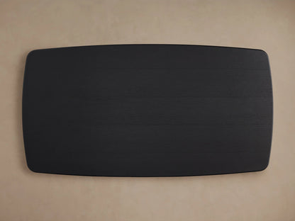 Dark wood tabletop of the Saint Germain Dining Table, featuring a smooth, polished finish and visible oak grain on a beige background.