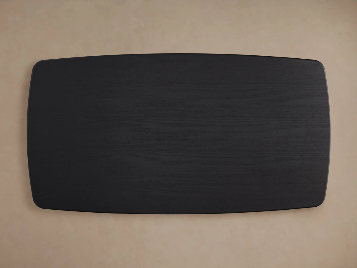 Corner view of the Saint Germain Wood Dining Table in Ebony finish, showcasing the smooth, dark oak veneer surface and subtle grain texture.