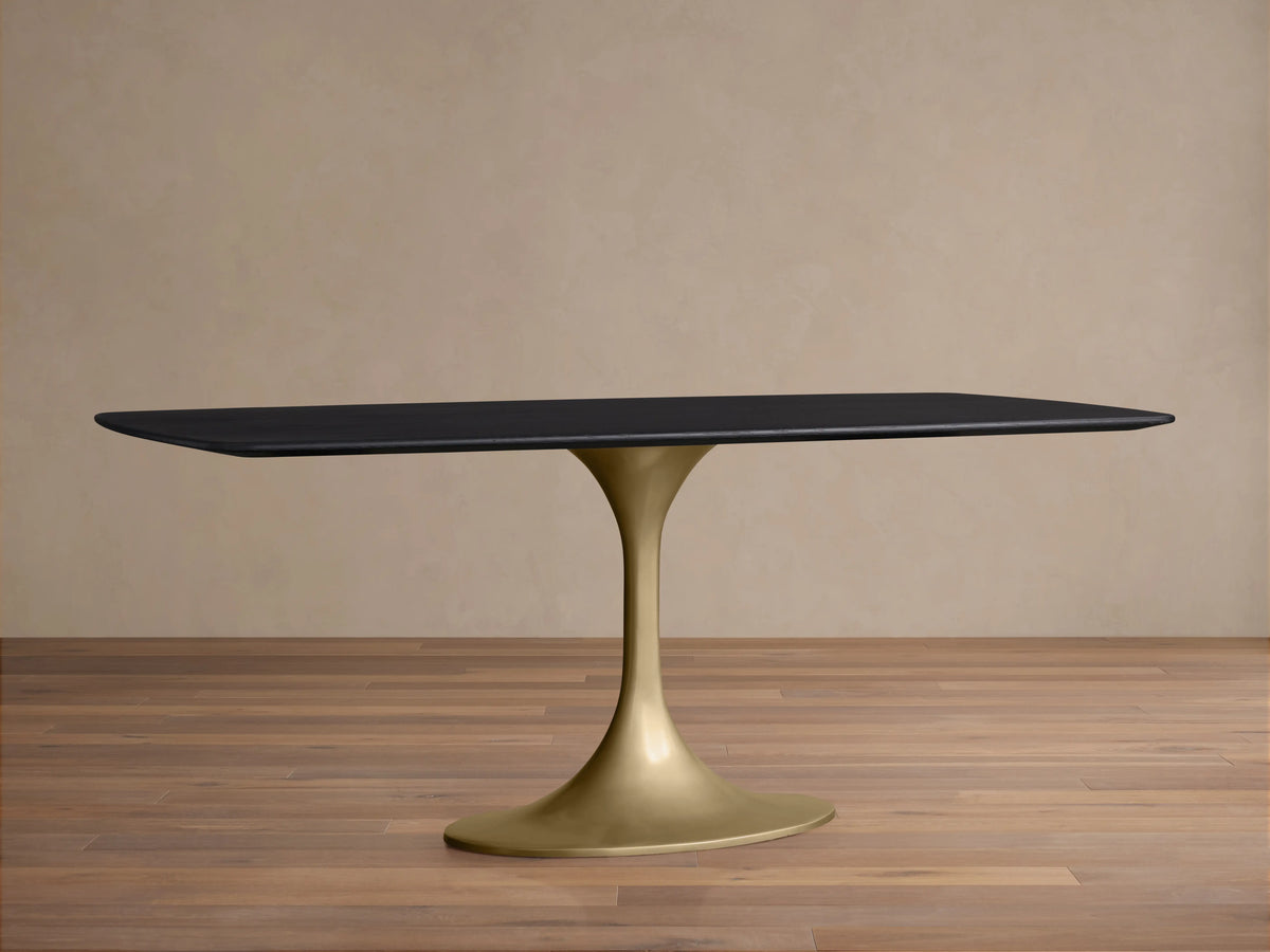 Rectangular Saint Germain Wood Dining Table with dark Ebony oak top and a sleek, curved steel base in Launette style, on wooden floor.