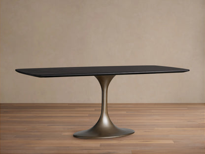 Saint Germain Wood Dining Table with a sleek rectangular top in Ebony finish and a sculpted steel Launette base on wooden flooring.