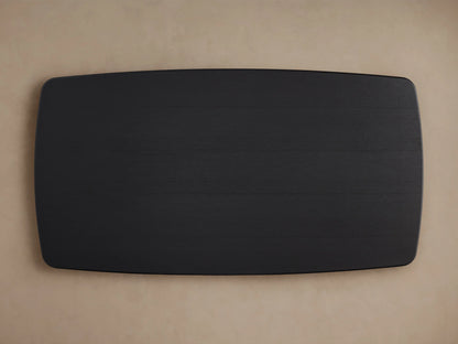 Saint Germain wood dining table with a close-up of the solid oak tabletop in a dark Ebony finish, showing smooth edges.