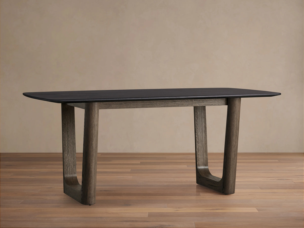 Saint Germain wood dining table with solid oak top in Ebony finish, rectangular shape, and Rennes base, placed on wood floor.
