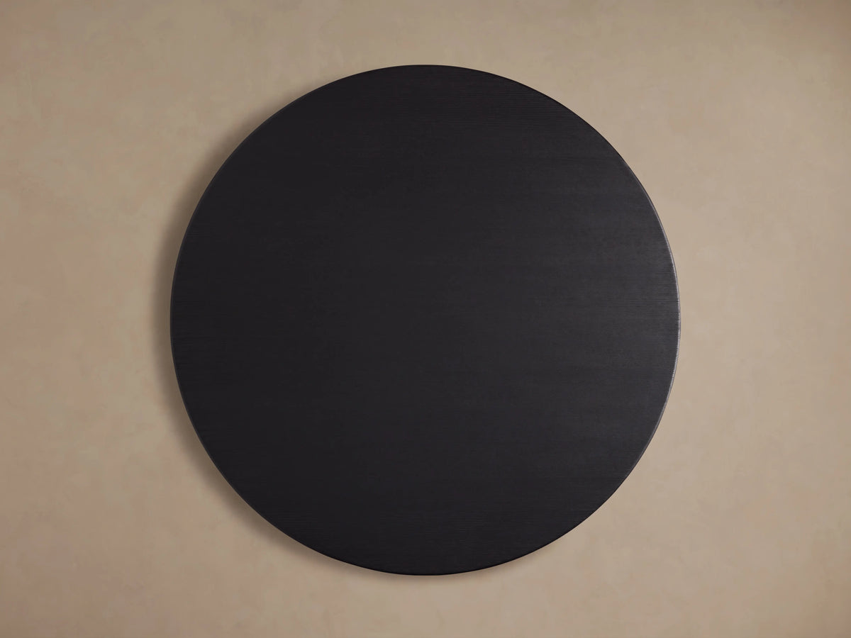 Round Saint Germain dining table, solid oak top with visible wood grain, finished in dark ebony, close-up view.