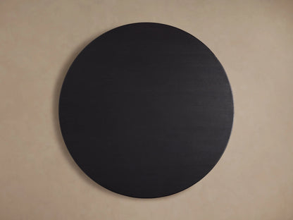 Round Saint Germain dining table, solid oak top with visible wood grain, finished in dark ebony, close-up view.