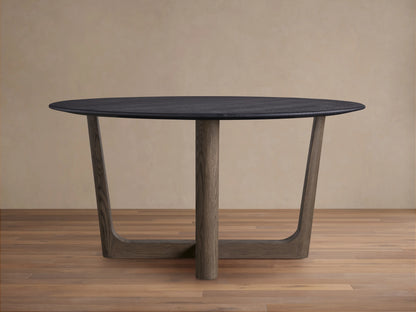 Saint Germain Round Wood Dining Table with a dark oak top and unique Rennes base, finished in natural wood, on a wooden floor.