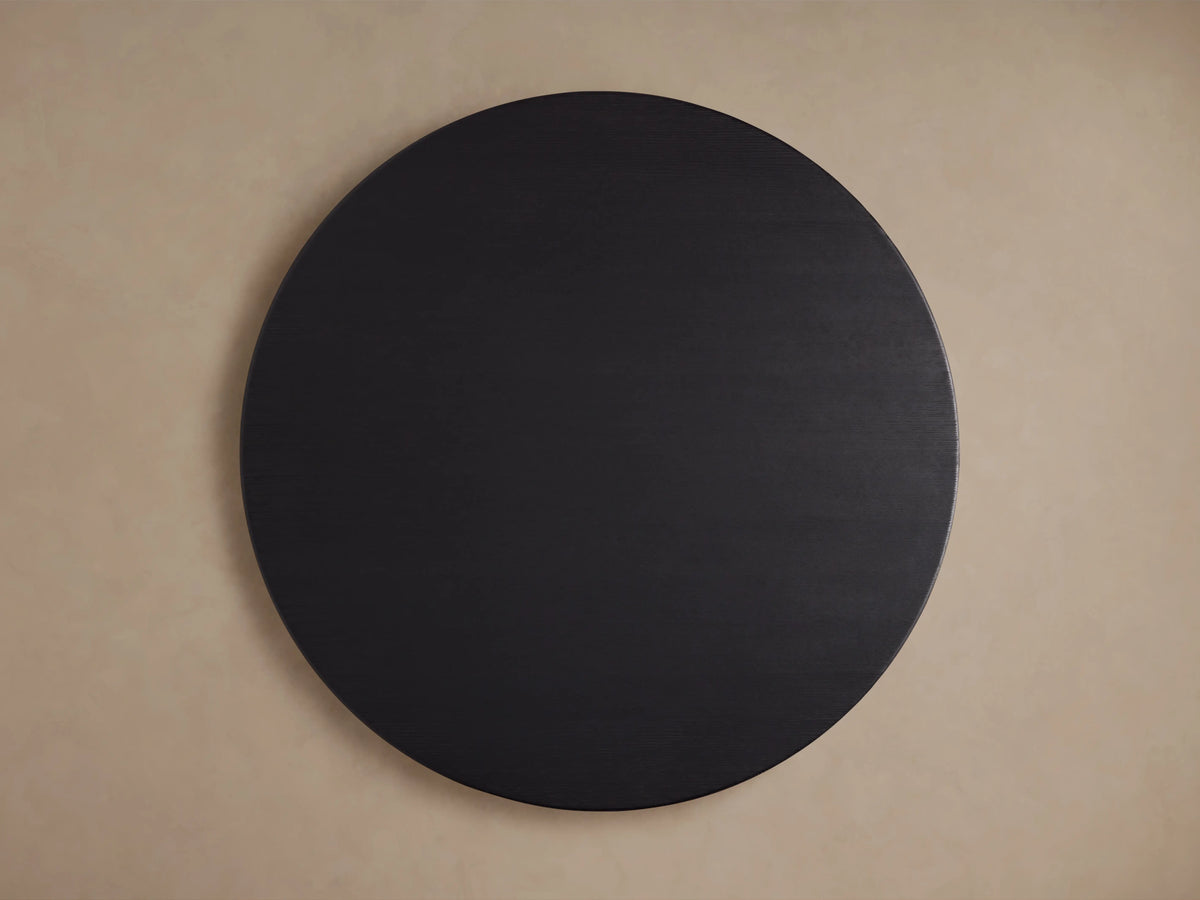 Round wood dining table top in a dark ebony finish against a neutral background, viewed from above.