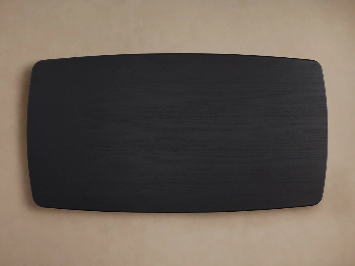 Saint Germain wood dining table top view, showing a smooth, rectangular ebony finish with rounded edges on a light background.