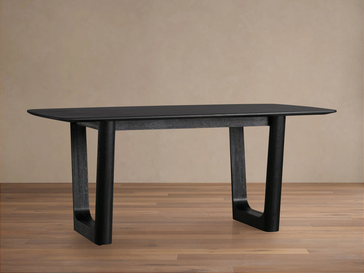 Saint Germain Wood Dining Table with a dark Ebony finish, rectangular top and sturdy Rennes base on a wooden floor.