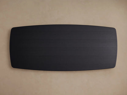 Saint Germain dining table with an ebony-finished rectangular oak top and base, set against a light neutral wall and wooden floor.