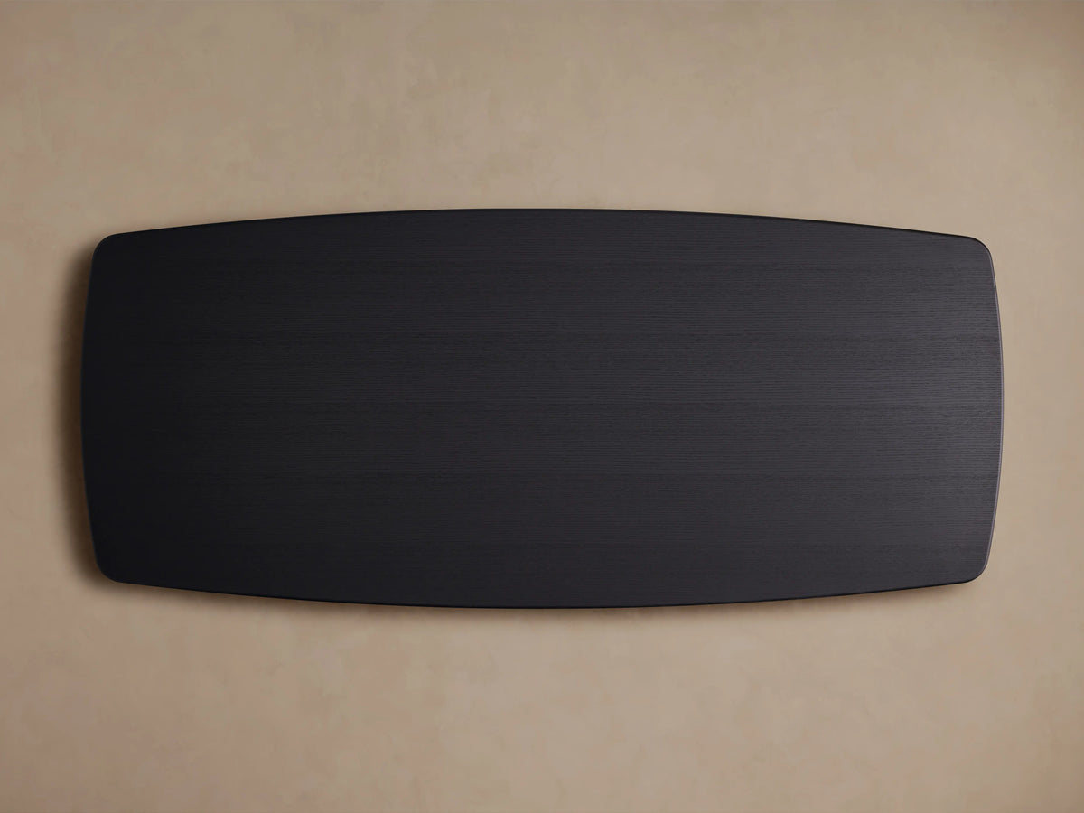 Saint Germain Wood Dining Table with Ebony finish, solid oak top, rounded edges, and dual Dauphine base on a wooden floor.