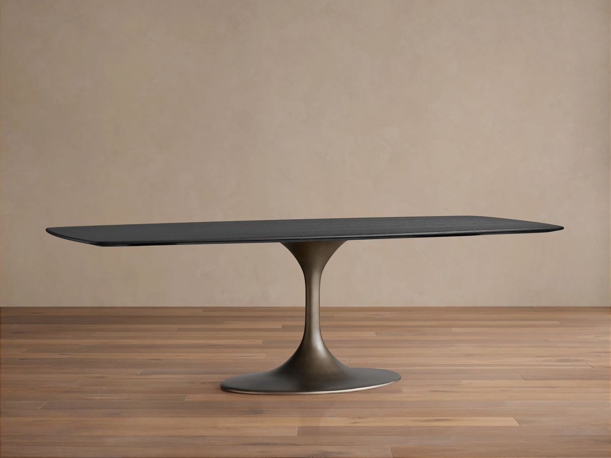Saint Germain Wood Dining Table with solid oak rectangular top in Ebony finish and steel Launette base on wooden floor.