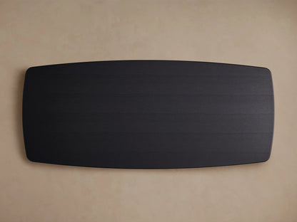 Corner view of Saint Germain Wood Dining Table in Ebony finish, showing smooth wood grain and rounded edges on a steel base.