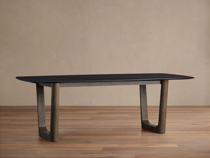Saint Germain Wood Dining Table with elongated rectangular oak top in dark finish and robust wooden legs on wooden floor.