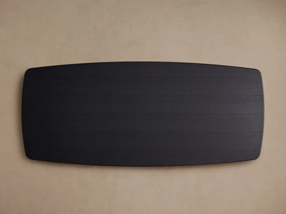 Close-up view of the Saint Germain Wood Dining Table's corner, showcasing a sleek ebony-finished oak tabletop with visible wood grains.