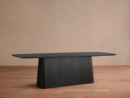 Saint Germain wood dining table with Toulouse base in ebony finish, rectangular top, and wide base on wood flooring.