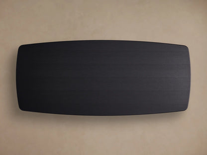 Close-up of Saint Germain Wood Dining Table's black ebony finish tabletop, showing wood grain and a rounded corner.