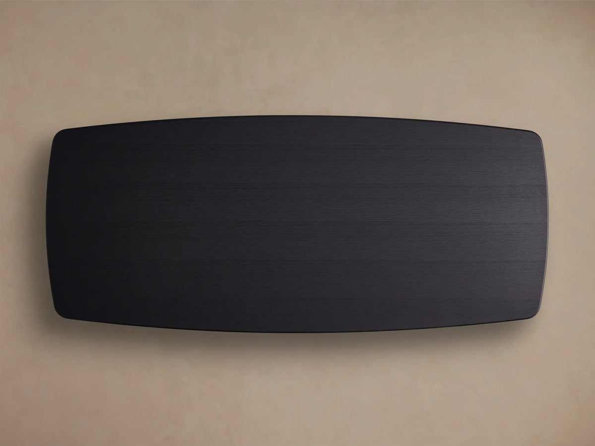 Corner of the Saint Germain Wood Dining Table showing a rectangular solid oak tabletop with a dark Ebony finish and visible wood grain.