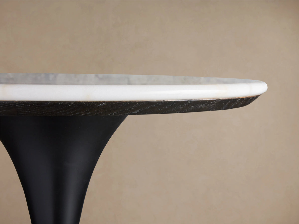 Round Enzo Bar Table with white marble top showing natural veining, supported by a black tulip-style iron base.