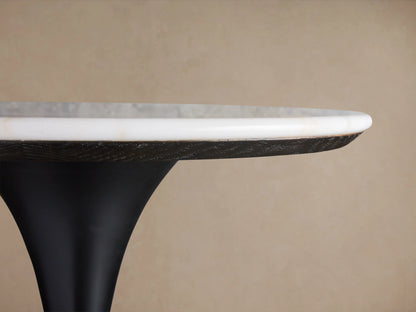 Round Enzo Bar Table with white marble top showing natural veining, supported by a black tulip-style iron base.