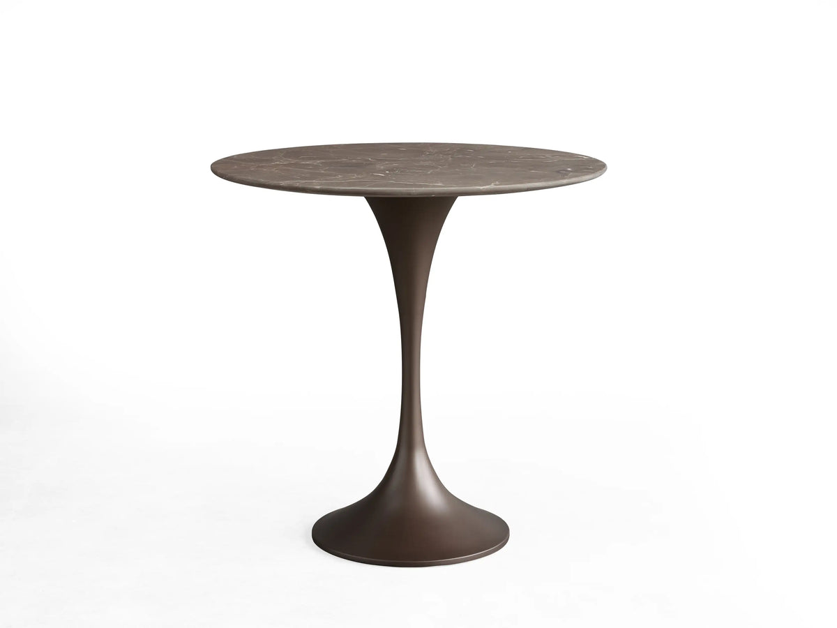 Round tabletop made of black marquina marble featuring white veining, viewed from above against a beige background.