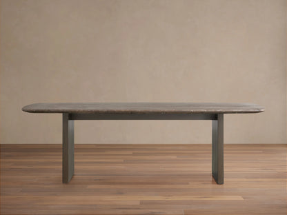 Saint Germain Stone Dining Table with oval espresso brown stone top and rectangular wood base on a wooden floor.