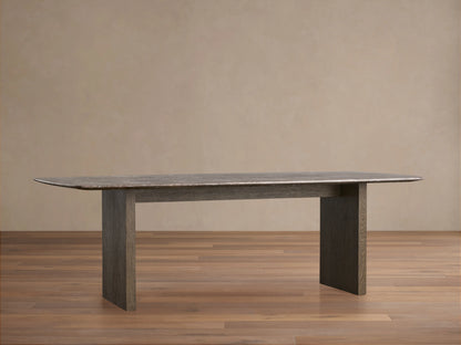 The image shows a close-up of the Saint Germain Dining Table with an espresso brown stone top, featuring natural veining and unique texture.