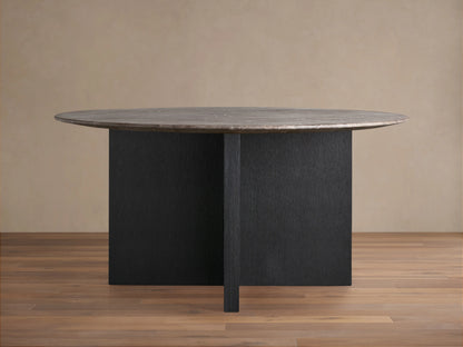Saint Germain round table with a brown stone top and dark wood base, set on a light wood floor against a beige wall.