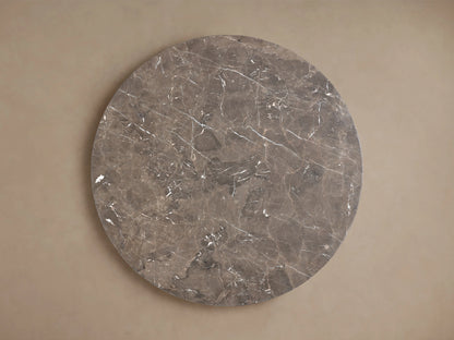 Saint Germain Round Stone Dining Table, close-up of dark brown marble top with intricate white and reddish natural veining.