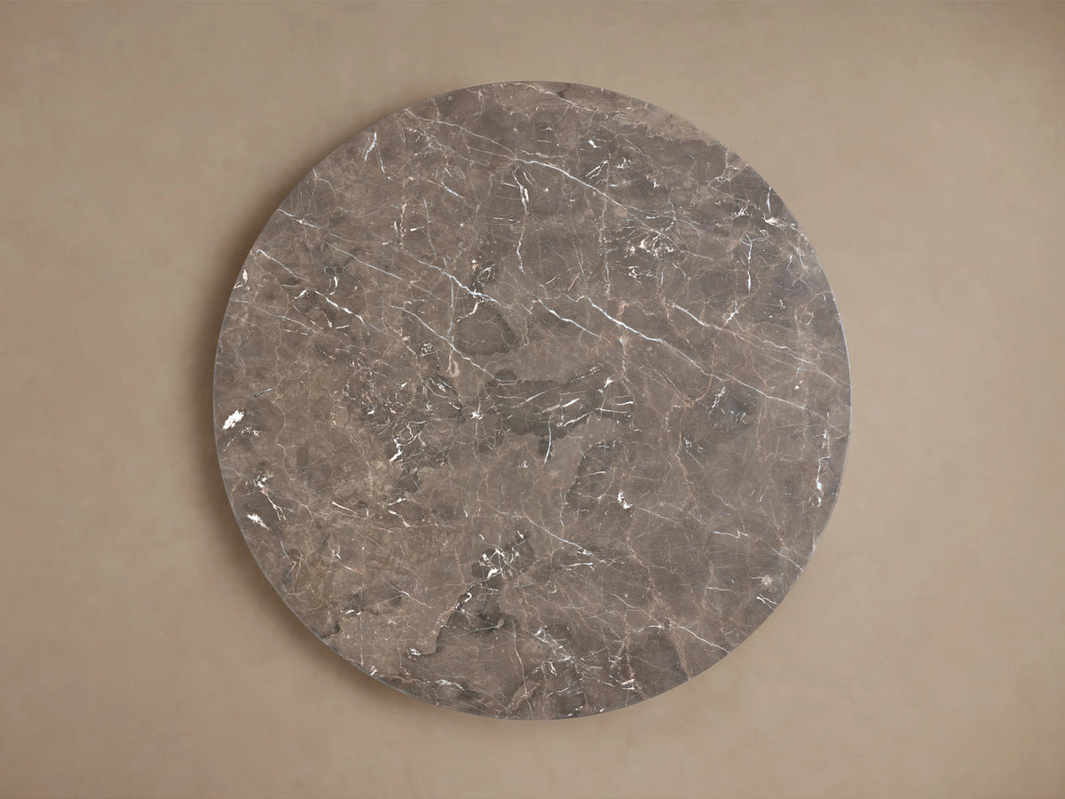 Round tabletop of the Saint Germain Dining Table made from espresso brown stone. Visible natural veining and mineral deposits create unique patterns.