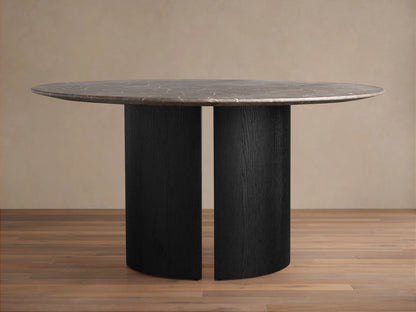 Saint Germain Round Stone Dining Table with a dark brown natural stone top & an ebony-finished Dauphine pedestal base.