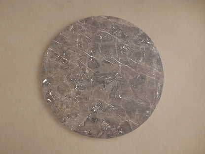 Saint Germain Round Dining Table: Close-up of espresso brown marble tabletop with white and reddish natural veining.