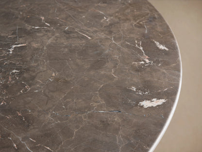 Round espresso brown stone tabletop with natural veining patterns. Edge detail visible, smooth polished surface.
