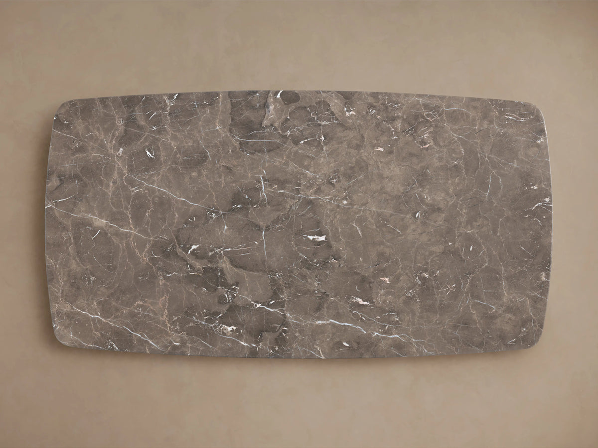 Stone tabletop in espresso brown with natural variations, veining, and swirling patterns. Smooth, rounded corner visible.