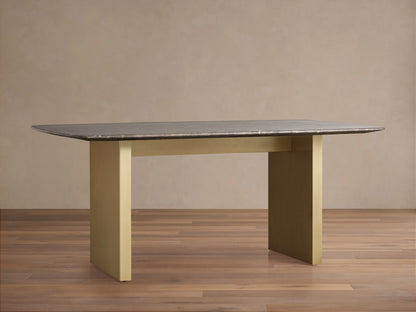 Dark stone dining table with a rectangular Carrara marble top featuring white veining, set against a neutral background.