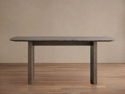 Saint Germain dining table with a rectangular stone top and a wood base in a neutral room. The table is positioned on a wooden floor.