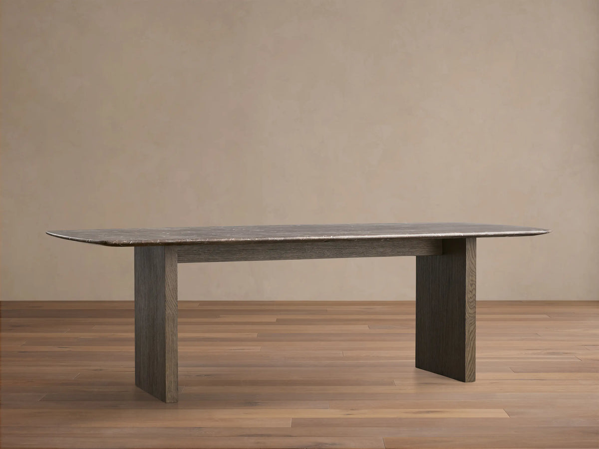 Front view of the Espresso Brown Saint Germain Stone Top Dining Table with Wood Clement Base, with two thick rectangular dark wood legs.