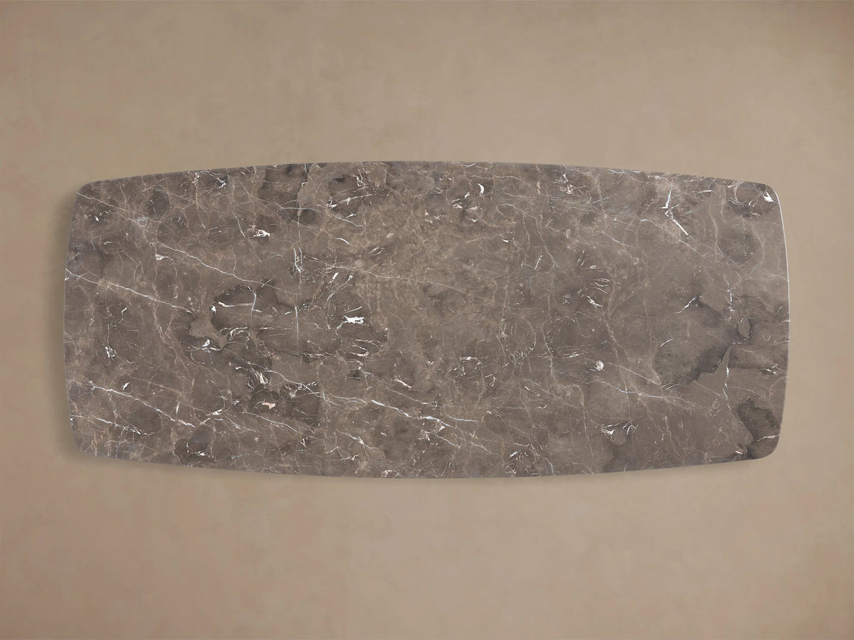 Close-up of the espresso brown stone top of the Saint Germain Stone Top Dining Table, showing white veining and a rounded edge.